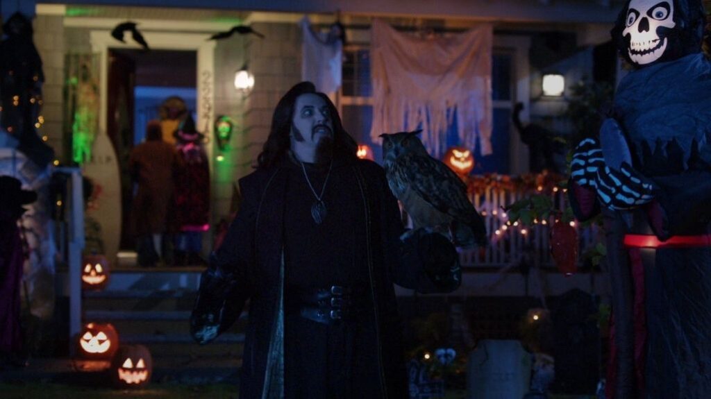 Spooky Buddies (2011) movie scene A man standing with Owl in hand in a scary environment.